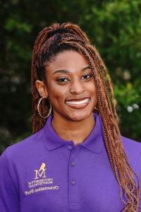 Photo of Allya Florence wearing a purple Orientation Leader polo shirt.