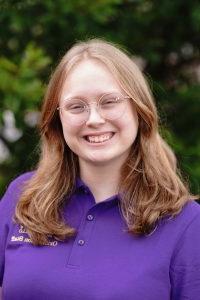 Photo of Bethany Singleton wearing a purple Orientation Leader polo shirt.